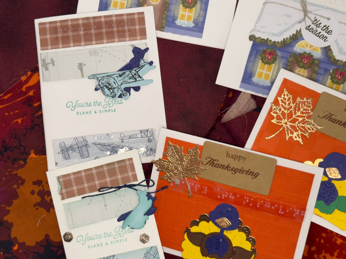 Close-up of the October box airplane card “You’re the Best, Plane & Simple,” gold glitter leaf “Happy Thanksgiving” blue-purple trim, snowy roof, and glowing window from A House Full of Cheer.