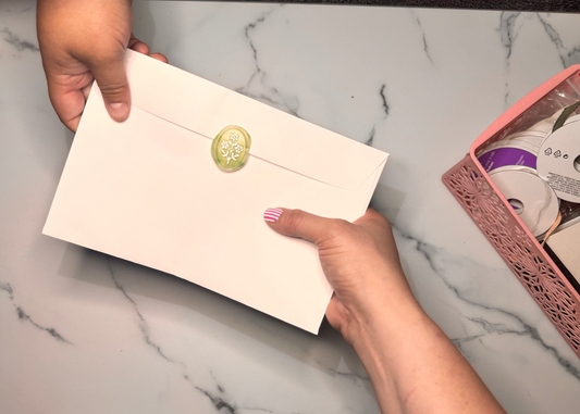 A finished greeting card ready to give with pride two people exchanging a card the back of a card showing a 3D embossed wax seal