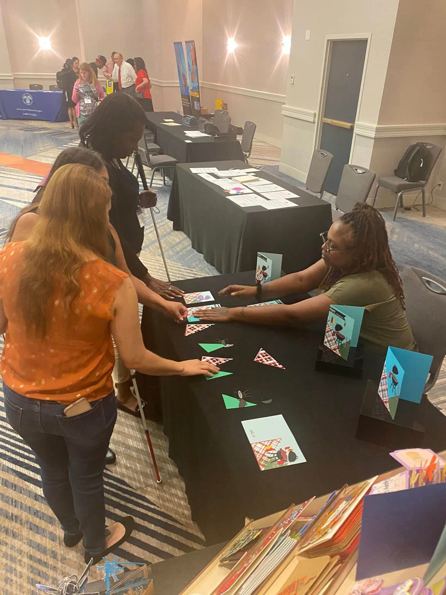 At the Phoenix NFB convention showcasing the Be Tactile program to come in 2023. pieces were available to layout on the card base with pre-assembled cards available. participants lay pieces out to understand layout.