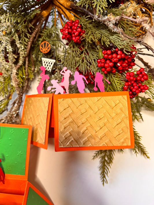 pink basketball girl players, black hoop and white net, orange and black basketball. shades of pink for the basketball players