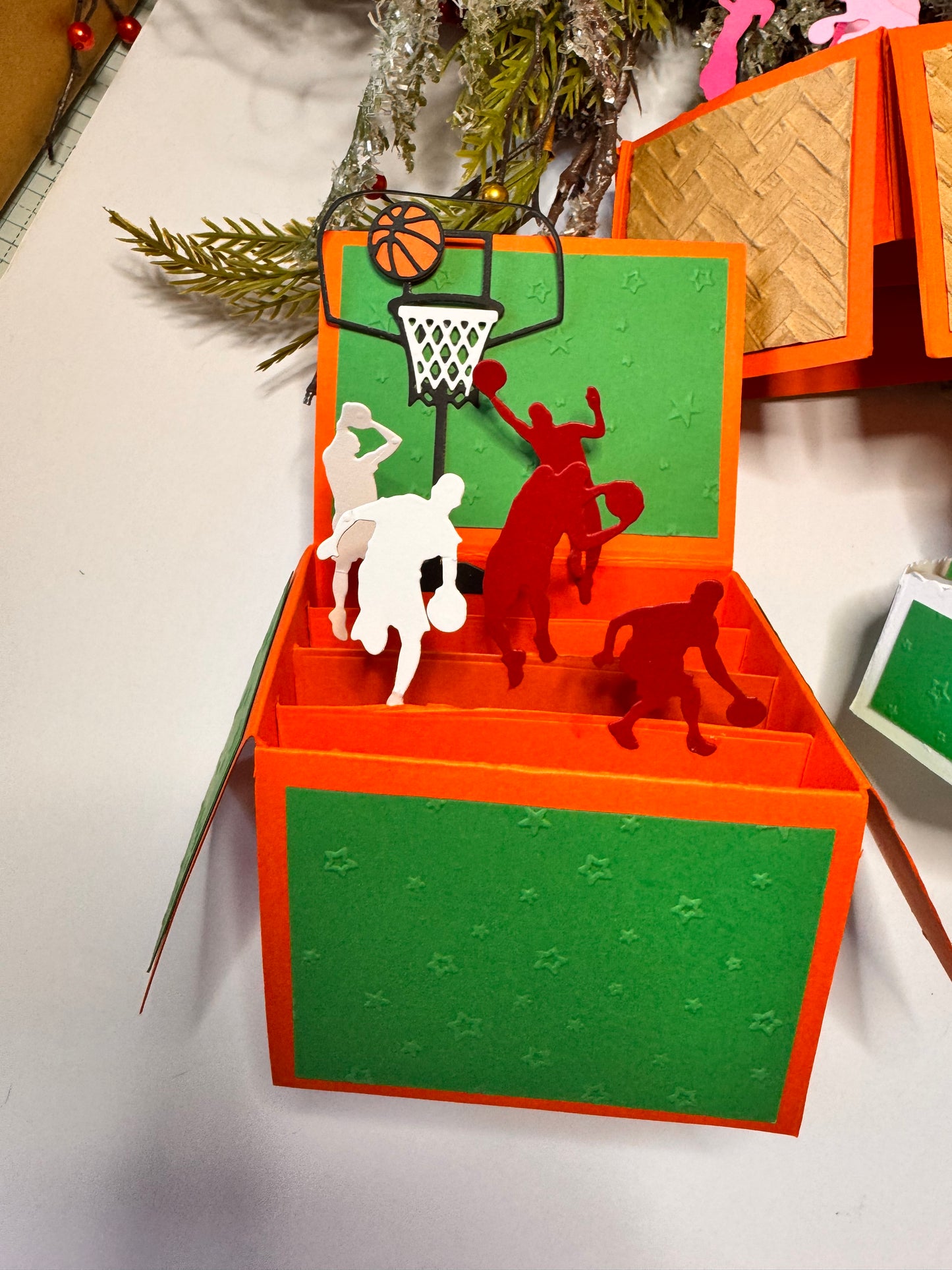 red and white basketball boy players, black hoop and white net, orange and black basketball.  