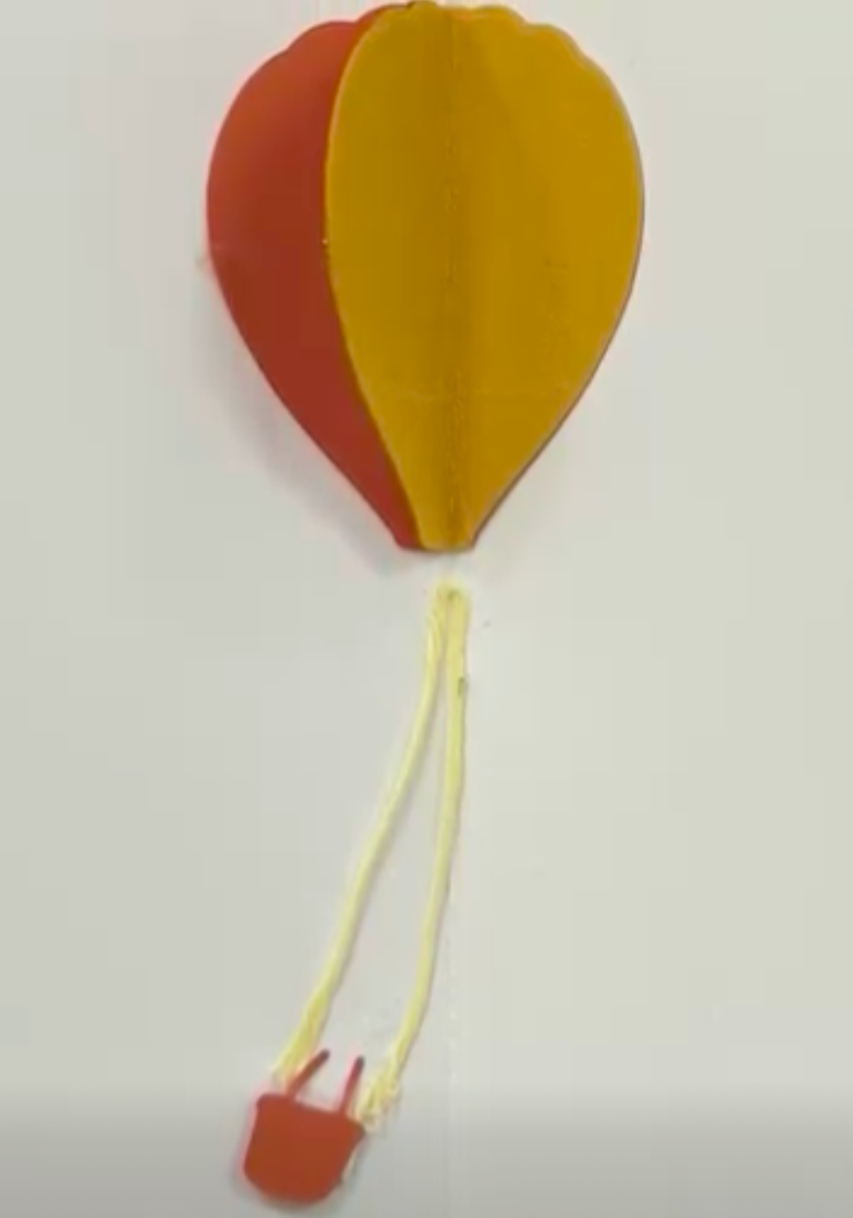 try-fold air balloon with red and yellow colors with string at the bottom holding the basket. string is yellow and basket is orange